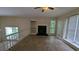 Open-concept living room featuring a fireplace and natural light at 345 Deerwood Dr, Suwanee, GA 30024
