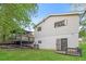 Spacious backyard with a deck, grassy lawn, and two-story exterior elevation at 6864 Maddox Rd, Morrow, GA 30260