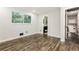 Bright bedroom featuring hardwood floors, a large window, and neutral paint at 6864 Maddox Rd, Morrow, GA 30260