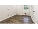 Bedroom with hardwood floors, neutral walls, large window, and natural light at 6864 Maddox Rd, Morrow, GA 30260