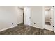 Bedroom with hardwood floors, neutral walls, and multiple entryways at 6864 Maddox Rd, Morrow, GA 30260