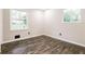 Bedroom featuring hardwood floors, neutral walls, and lots of natural light at 6864 Maddox Rd, Morrow, GA 30260