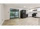 Open kitchen with white cabinets, black appliances, and sliding door to the deck at 6864 Maddox Rd, Morrow, GA 30260
