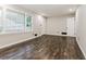 Bright living room featuring hardwood floors, fresh paint, and a large window at 6864 Maddox Rd, Morrow, GA 30260