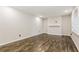 Bright living room featuring hardwood floors, fresh paint, and a large window at 6864 Maddox Rd, Morrow, GA 30260