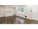 Bright living room featuring hardwood floors, fresh paint, and a large window at 6864 Maddox Rd, Morrow, GA 30260