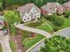 Aerial view showcasing a well-maintained home with landscaped yard, long driveway, and established neighborhood at 1225 Elk Ridge Cv, Alpharetta, GA 30005