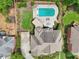 Expansive backyard with a sparkling in-ground pool, lush landscaping, and outdoor seating areas at 1225 Elk Ridge Cv, Alpharetta, GA 30005