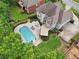 Aerial view of a home with a backyard pool and patio area at 1225 Elk Ridge Cv, Alpharetta, GA 30005