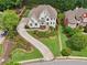 Aerial view of the house showing its long driveway and lush front yard at 1225 Elk Ridge Cv, Alpharetta, GA 30005