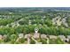 Aerial shot highlighting a home surrounded by lush greenery in a well-established neighborhood with mature trees at 1225 Elk Ridge Cv, Alpharetta, GA 30005