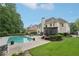 Serene backyard retreat with a sparkling pool, lounge chairs, and well-maintained lawn at 1225 Elk Ridge Cv, Alpharetta, GA 30005