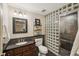 Well-lit bathroom featuring a stone countertop, glass block shower, and classic fixtures at 1225 Elk Ridge Cv, Alpharetta, GA 30005