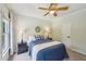 Comfortable bedroom featuring a ceiling fan, neutral walls, and natural light from the window at 1225 Elk Ridge Cv, Alpharetta, GA 30005