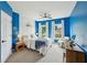 Vibrant bedroom features blue walls, white trim, a ceiling fan, and natural light at 1225 Elk Ridge Cv, Alpharetta, GA 30005
