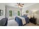 Bright bedroom with two windows, blue accents, and modern furnishings at 1225 Elk Ridge Cv, Alpharetta, GA 30005