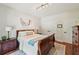 Bedroom with hardwood floors, a sleigh bed, and ample closet space, creating a cozy retreat at 1225 Elk Ridge Cv, Alpharetta, GA 30005