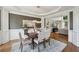 Elegant dining room with modern chandelier, hardwood floors, and an open layout for entertaining at 1225 Elk Ridge Cv, Alpharetta, GA 30005