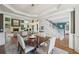 Dining room showcasing modern lighting, hardwood floors, and an open floor plan to the living room at 1225 Elk Ridge Cv, Alpharetta, GA 30005