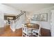 Dining room with hardwood floors, a round table, and stairway access, creating an inviting space at 1225 Elk Ridge Cv, Alpharetta, GA 30005