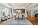 Elegant dining room featuring hardwood floors, crown molding, and natural light from a large window at 1225 Elk Ridge Cv, Alpharetta, GA 30005