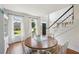 Charming dining room featuring hardwood floors, a round table, and views of the landscaped front yard at 1225 Elk Ridge Cv, Alpharetta, GA 30005