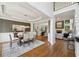 Spacious dining room with hardwood floors and modern lighting that opens to the living room at 1225 Elk Ridge Cv, Alpharetta, GA 30005