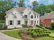 Charming two-story home with a lush front yard and manicured landscaping at 1225 Elk Ridge Cv, Alpharetta, GA 30005