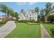 Beautiful home showcases an expansive lawn, mature trees, and inviting curb appeal at 1225 Elk Ridge Cv, Alpharetta, GA 30005