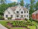 Charming two-story home with a lush front yard and manicured landscaping at 1225 Elk Ridge Cv, Alpharetta, GA 30005