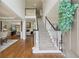Grand foyer with a soaring ceiling, elegant staircase with iron railings, and hardwood floors at 1225 Elk Ridge Cv, Alpharetta, GA 30005