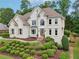 Stately home boasts manicured landscaping, large windows, and a welcoming front entrance at 1225 Elk Ridge Cv, Alpharetta, GA 30005