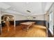 Large game room featuring pool table, wood floors, and updated lighting fixture at 1225 Elk Ridge Cv, Alpharetta, GA 30005