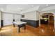 Recreation room with wood floors, air hockey table, and easy access to kitchen at 1225 Elk Ridge Cv, Alpharetta, GA 30005