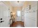 Stylish hallway boasts decorative wallpaper, modern console table, and dark hardwood flooring at 1225 Elk Ridge Cv, Alpharetta, GA 30005