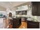 Charming kitchen boasts black cabinets, stainless steel appliances, and granite countertops at 1225 Elk Ridge Cv, Alpharetta, GA 30005