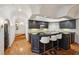 Finished basement kitchen with hardwood floors, black cabinets and counter tops with barstool seating at 1225 Elk Ridge Cv, Alpharetta, GA 30005