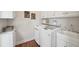 Functional laundry room with white cabinets, sink, washer, and dryer at 1225 Elk Ridge Cv, Alpharetta, GA 30005