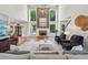 Bright living room with a fireplace, soaring ceilings, large windows overlooking pool, and stylish decor at 1225 Elk Ridge Cv, Alpharetta, GA 30005