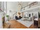 Spacious living area with a fireplace, hardwood floors, tall ceilings, open floor plan and elegant decor at 1225 Elk Ridge Cv, Alpharetta, GA 30005
