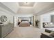 Spacious main bedroom suite with tray ceiling, sitting area, and luxurious ensuite bathroom at 1225 Elk Ridge Cv, Alpharetta, GA 30005