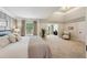 Spacious main bedroom featuring a king bed, tray ceiling, large windows, and adjoining sitting room at 1225 Elk Ridge Cv, Alpharetta, GA 30005