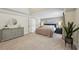 Serene main bedroom featuring soft lighting, tray ceilings, neutral tones, and ample space at 1225 Elk Ridge Cv, Alpharetta, GA 30005