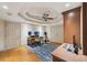 Home office offers natural light, a tray ceiling with fan, and hard wood flooring at 1225 Elk Ridge Cv, Alpharetta, GA 30005