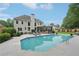 Inviting backyard features a large swimming pool, patio area, and lush greenery at 1225 Elk Ridge Cv, Alpharetta, GA 30005