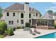 Expansive backyard featuring a large pool, covered patio, and ample seating at 1225 Elk Ridge Cv, Alpharetta, GA 30005
