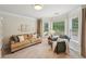 Comfortable sitting area bathed in natural light from multiple windows with stylish furnishings at 1225 Elk Ridge Cv, Alpharetta, GA 30005