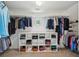 Large walk-in closet with ample storage space for clothing and accessories on multiple shelves and racks at 1225 Elk Ridge Cv, Alpharetta, GA 30005