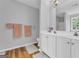 Bathroom featuring double vanity, hardwood floors, and a large mirror at 190 Crestworth Ct, Powder Springs, GA 30127