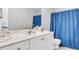 Bathroom featuring a white vanity, a large mirror, and a blue shower curtain at 190 Crestworth Ct, Powder Springs, GA 30127
